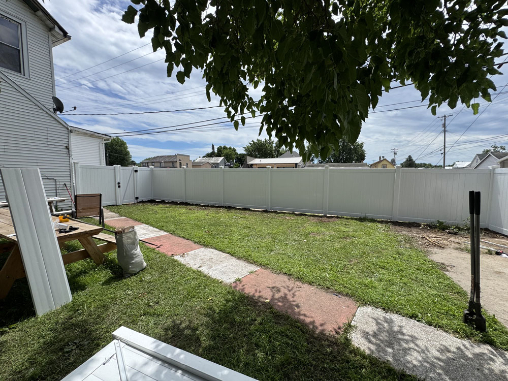 White Vinyl Fence installed in a large yard