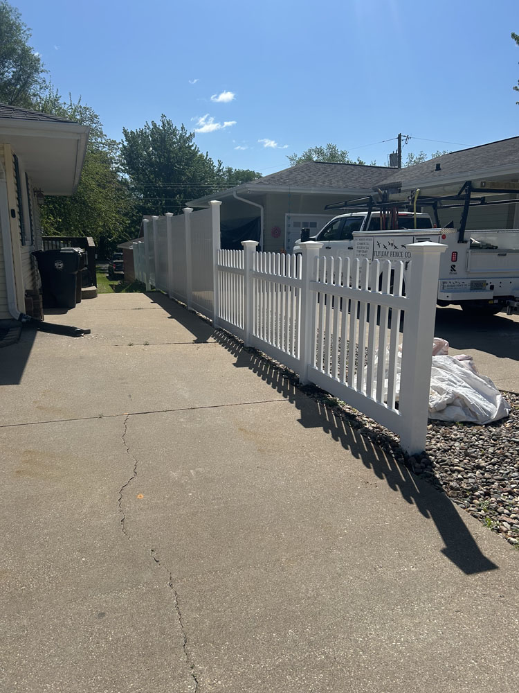 Installed white ornamental vinyl fencing