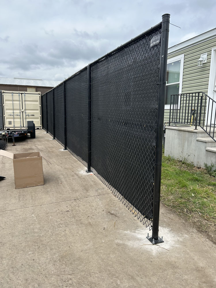 A fence on a sidewalk.